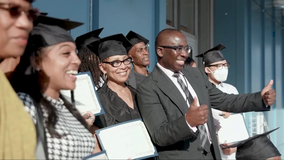 Graduates of the InTOuch program stand together with ith Dr. Olajide A. Williams for a photo. 