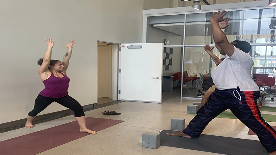 Dodge Fitness instructor, Autumn, leads class of individuals through a series of movies inside the Columbia Wellness Center.